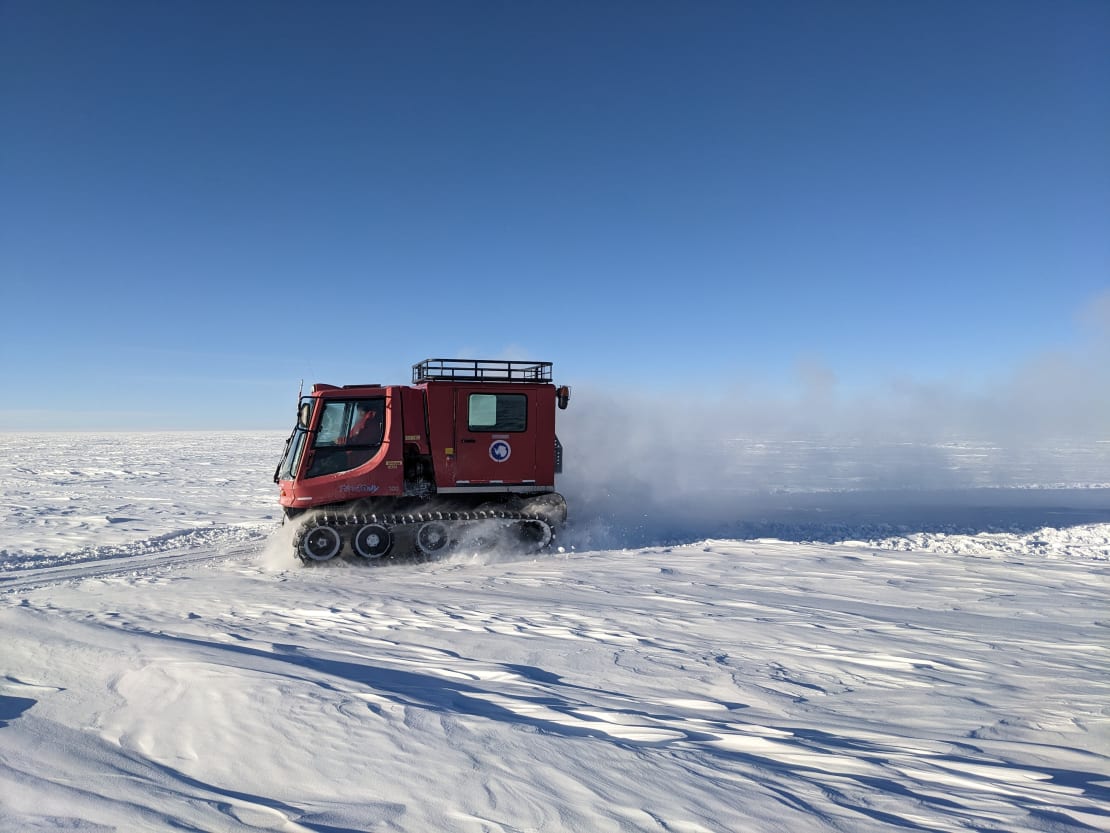 Side view of PistenBully, snow vehicle, moving along the skiway at the South Pole.