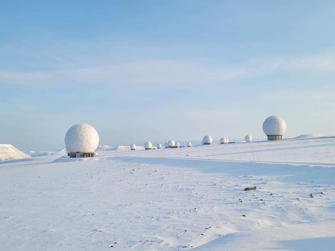 A bunch of satellites over snow-covered ground at the Svalbard Satellite Station