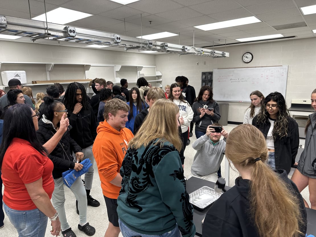 People around a table in a lab