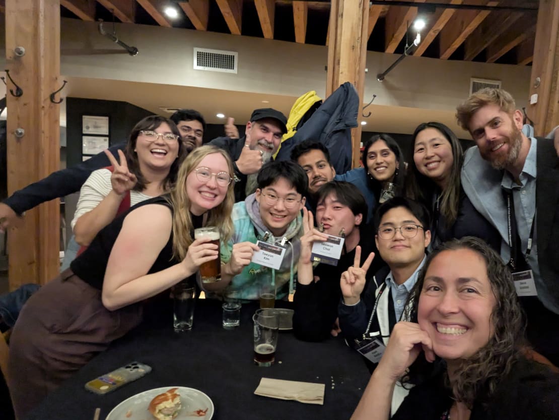 A group of people posing for a photo at a table