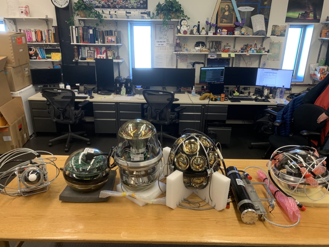 Optical modules lined up for display on a long table.