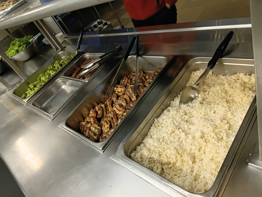 Warming trays filled with rice, meats, vegetables.