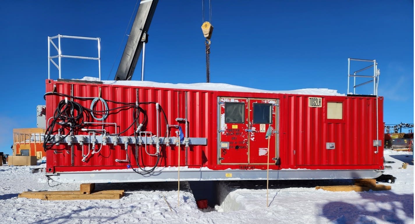 A red tower of operations building over a snow trench