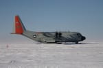 Side view of an LC-130 plane on the ice after landing at the South Pole.