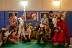 Group photo, some in space-related costumes, in front of poster for Yuri’s Night.