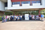 A group of people posing in front of a building