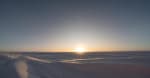 Bright moon on the horizon at the South Pole, looking almost like the sun.