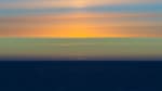 Sun’s green flash visible at sunset, with colorful cloud-filled sky.