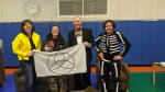 South Pole personnel holding up flag for their Polympics.