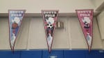 Three sports-themed pennants hung from ceiling.