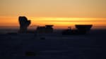 Yellow sky at South Pole sunset, with Dark Sector building tops in dark shadow.