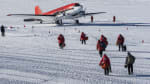 Departing summer personnel walking out to awaiting plane on the skiway at South Pole.