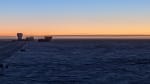 Clear blue sky changing to orange along the horizon at the South Pole sunset.