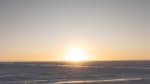 Bright moon on the horizon at the South Pole, looking almost like the sun.