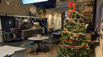 A decorated Christmas tree with presents below it in the South Pole station galley.