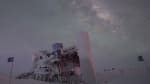 The IceCube Lab with frosted exterior in winter, Milky Way seen overhead.