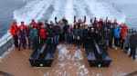 A group of people posing for a picture on a boat