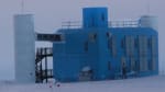 The IceCube Lab seen from a distance, with a darkening cloudy sky before sunset.