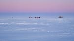 Hazy pink sky at twilight over Dark Sector at the South Pole.