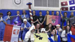 Group photo in South Pole gym with people in costumes and/or holding flags.