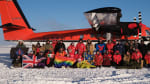 Wintover group photo with a twin otter plane as backdrop.