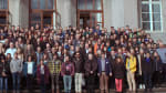 A group of people posing in front of a building
