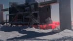 The IceCube Lab under a bright moon with a little aurora in the sky, too.