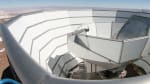 The Atacama Cosmology Telescope viewed from the top of the outer ground screen. The top half of the segmented, primary mirror can be seen above the inner ground screen that moves with the telescope.