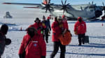 People getting off an LC-130 plane at the South Pole.