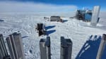 Looking down at the IceCube Lab and a large wrapped-up hose reel from vantage point of nearby drill tower.