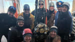 Group photo of nine drillers surrounding a module to be deployed.
