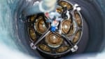 Close-up of module as it is being lowered into a drilled-out hole in the ice.