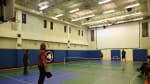 Four people on gym court to play pickleball.