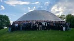 A group of people posing for a photo in front of the Planetarium Bochum.