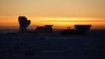 Yellow sky at South Pole sunset, with Dark Sector building tops in dark shadow.