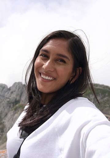 A woman with long brown hair taking a selfie.