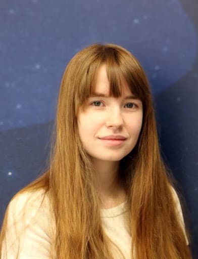 A headshot of a woman with light brown hair.