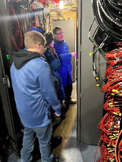 Small group tour inside IceCube Labe, mass or orange computer cables off to right.