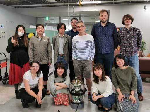 Group photo around IceCube D-Egg sensor.