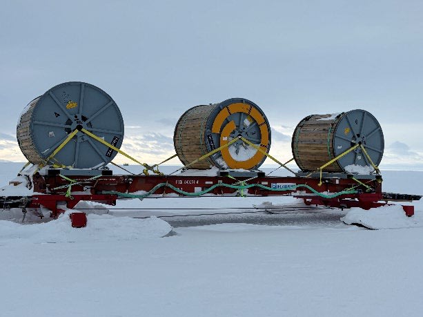 Large spools of cable assemblies on sleds, waiting to be attached to South Pole traverse.