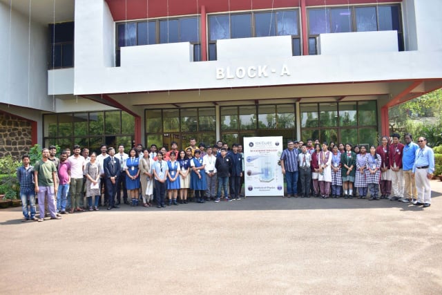 A group of people posing in front of a building