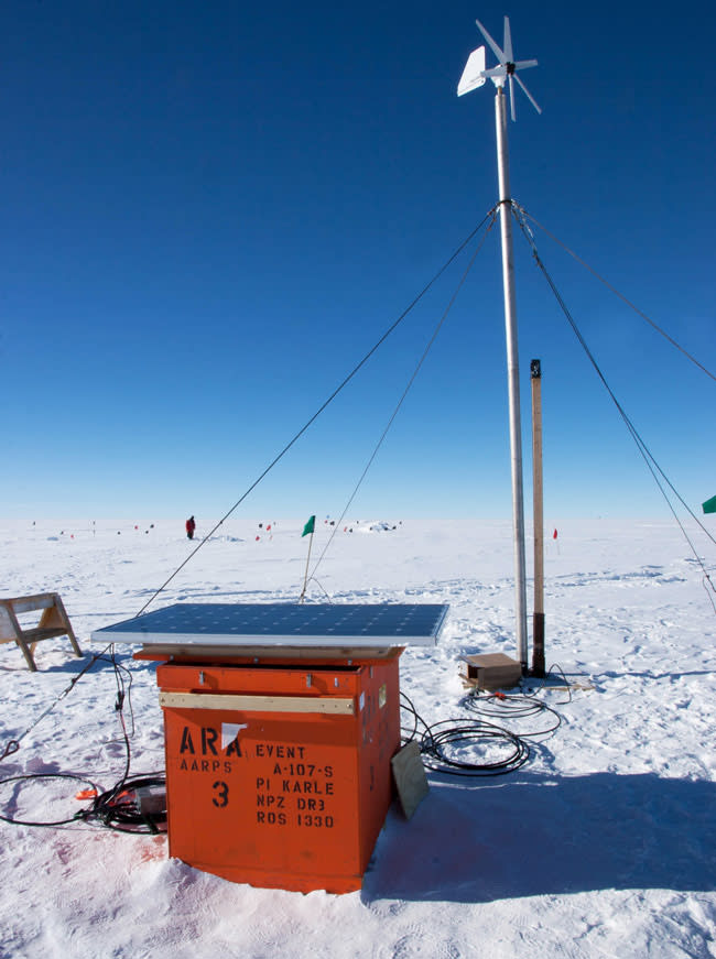 An Askaryan Radio Array solar panel rests on top of a gear box before being installed next to a prototype wind turbine