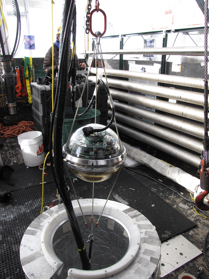 Dozens of specialized DOM detectors are embedded 1,500 feet below the ice to spot neutrinos