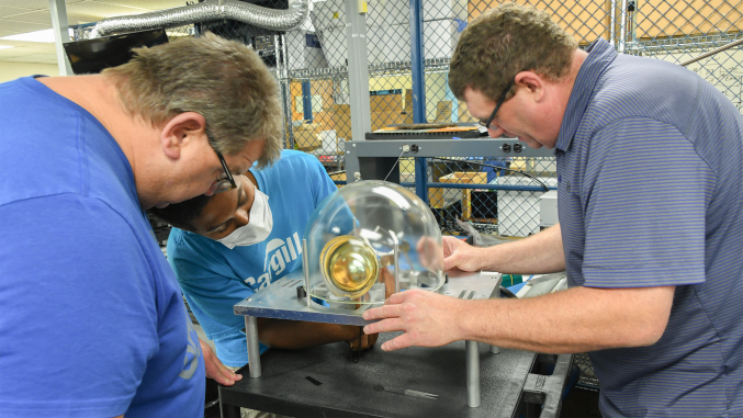 Close-up of three people working in lab.