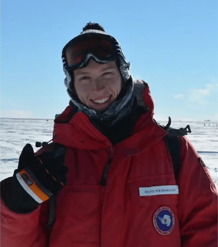 A man in cold weather gear at the South Pole