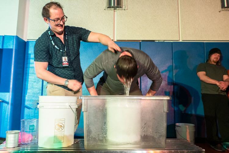 Water dripping from someone’s head who was just dunked into container of water.