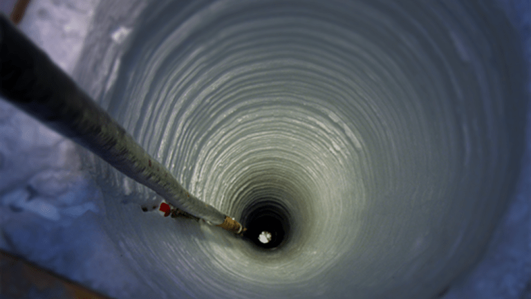 IceCube DOM being lowered into hole in ice.