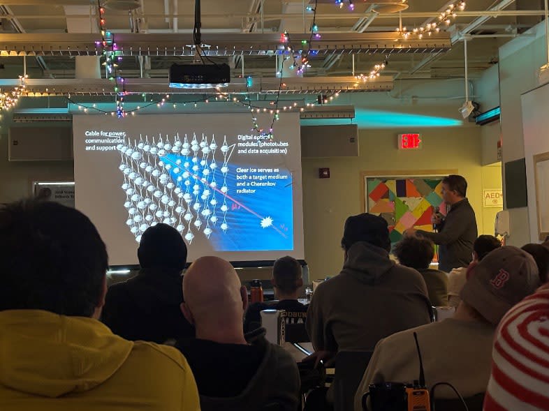 Slide on a screen while person gives a talk in darkened room.