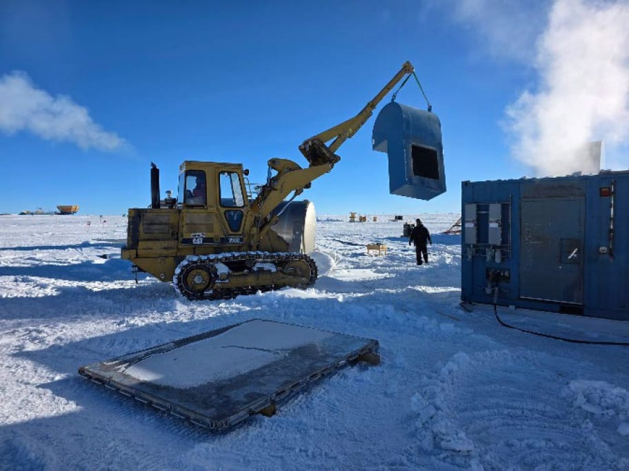 Heavy equipment lifting off a piece of an Upgrade building.