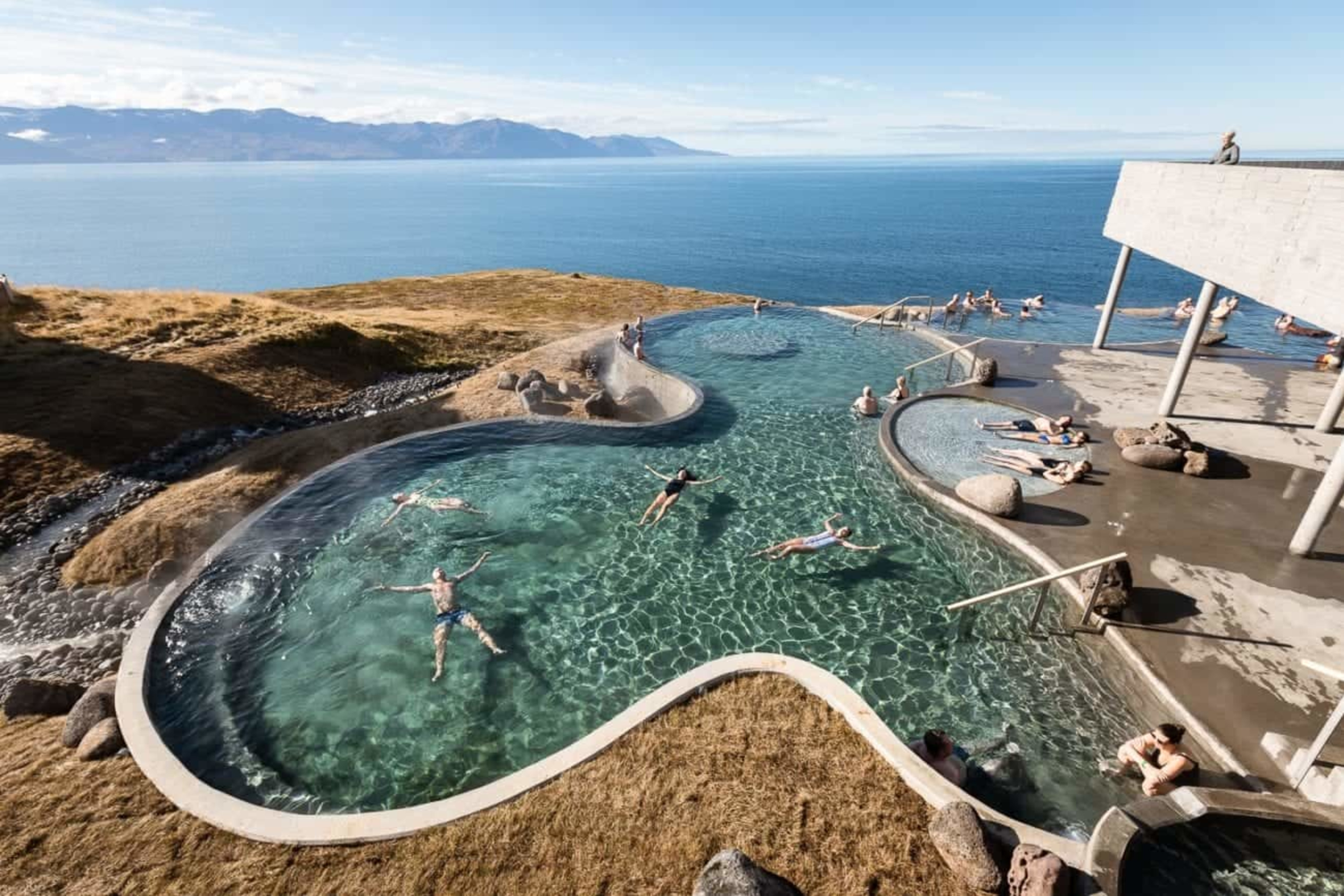 People enjoying GeoSea baths in Husavik